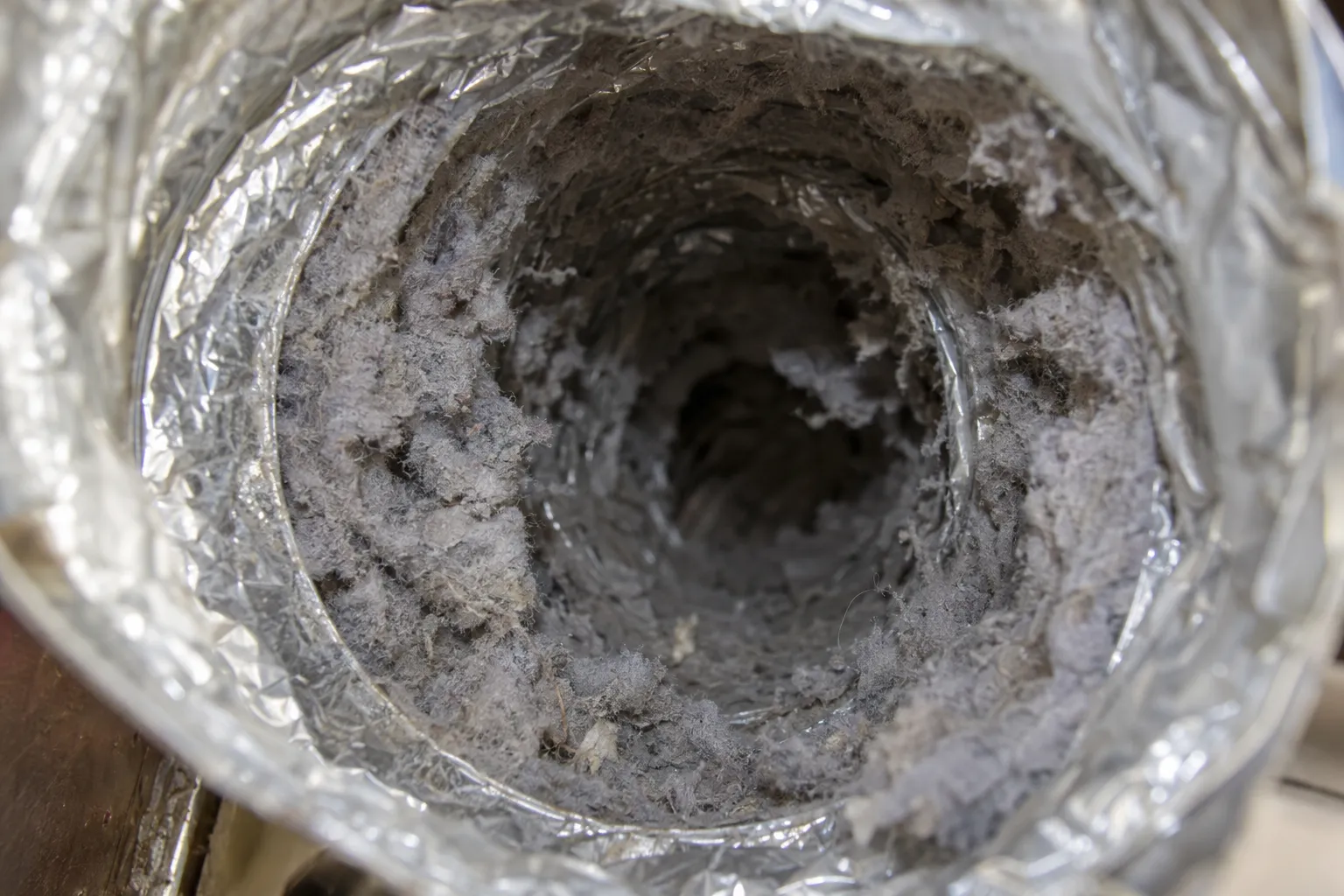 Inside a foil dryer vent duct coated with grey lint